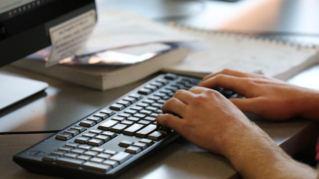 Student hands on a keyboard searching on a computer.